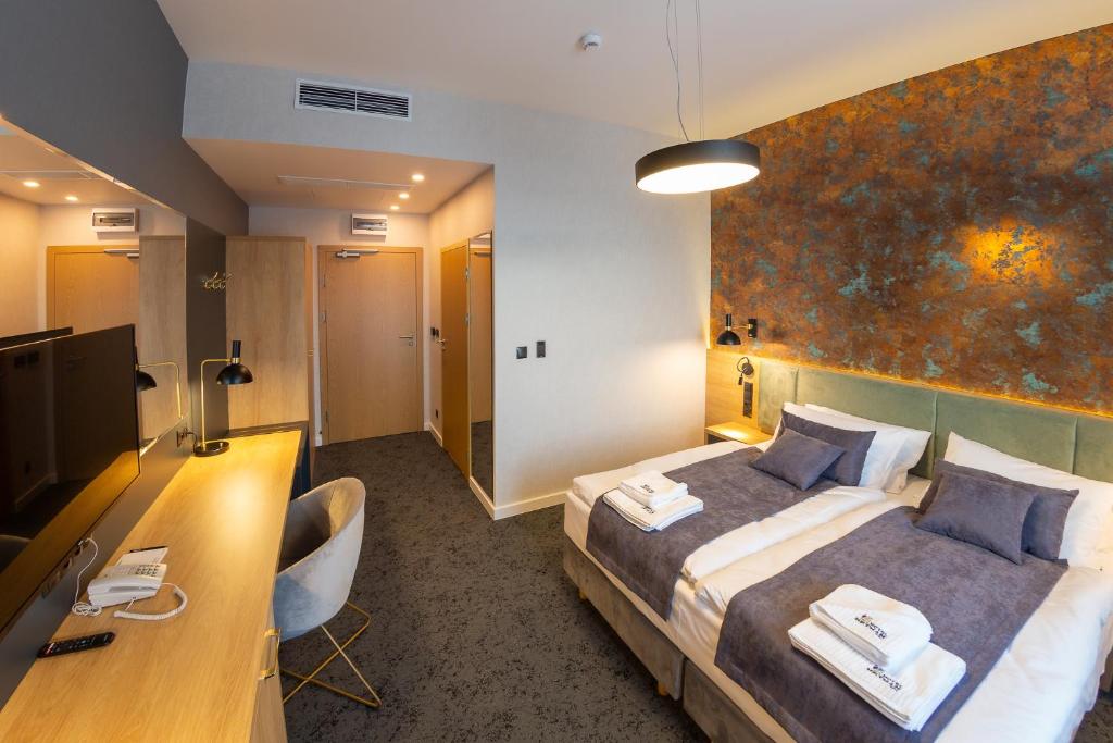 Postel nebo postele na pokoji v ubytování Hotel & SPA Hetman