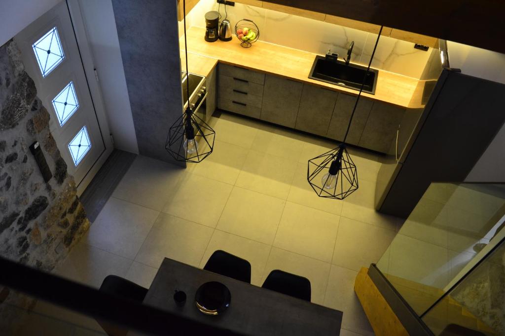an overhead view of a kitchen with a table and chairs at Fontana Leone in Spílion