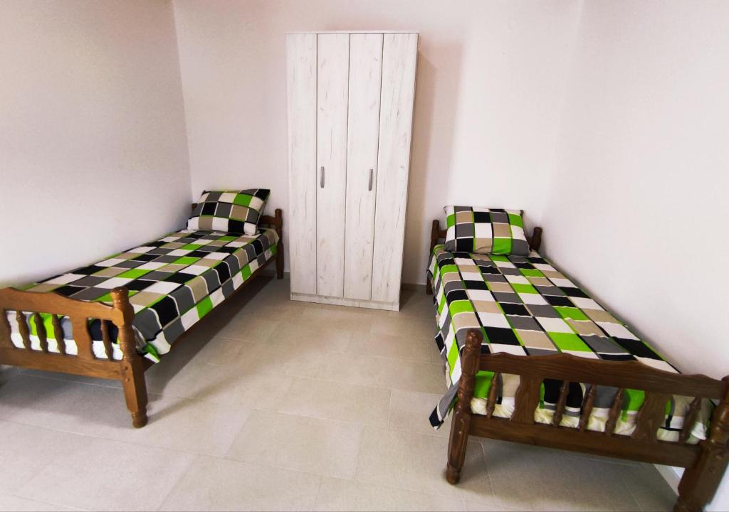 Łóżko lub łóżka w pokoju w obiekcie Celtis Shade House