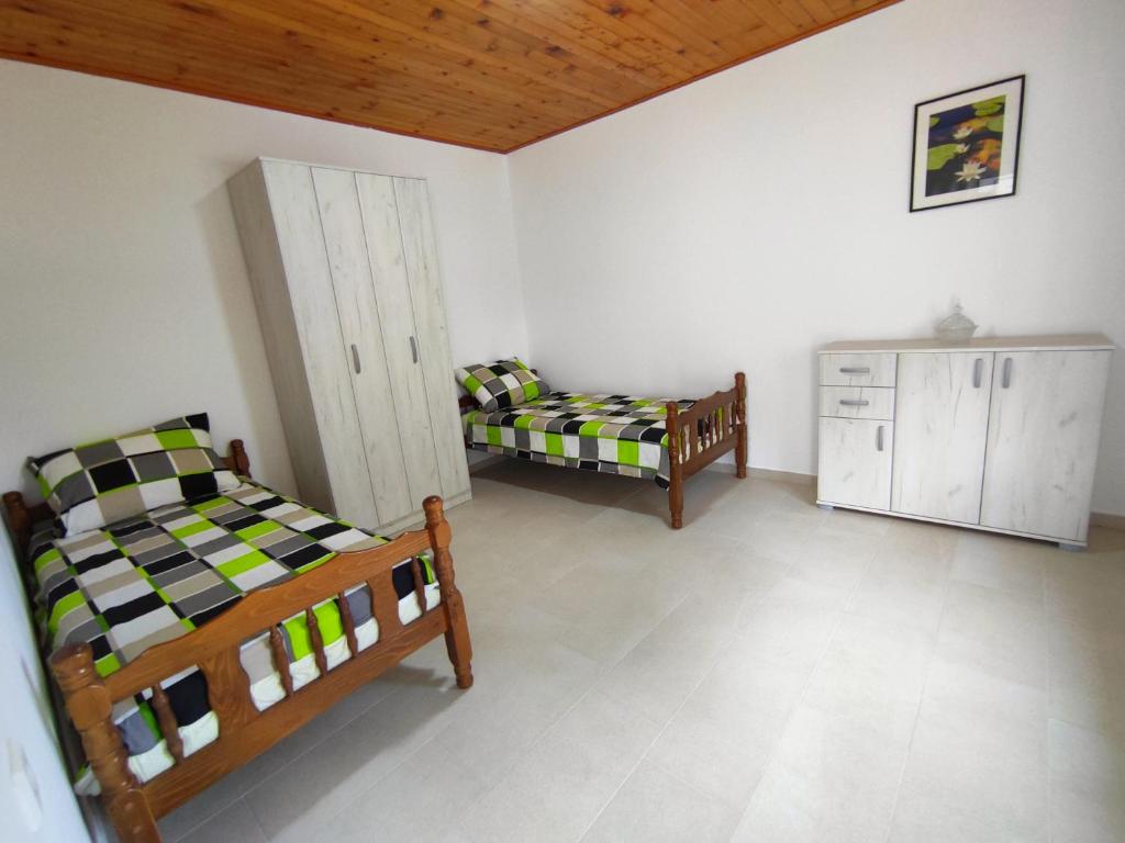 Łóżko lub łóżka w pokoju w obiekcie Celtis Shade House