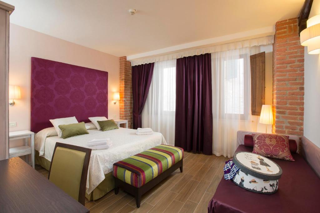 Postel nebo postele na pokoji v ubytování Hotel Alma Domus