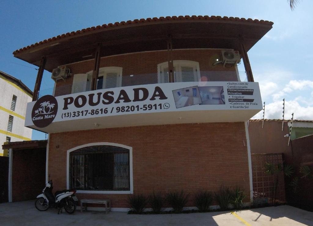 a building with a sign that reads proubadda on it at Pousada Costa Mare in Bertioga