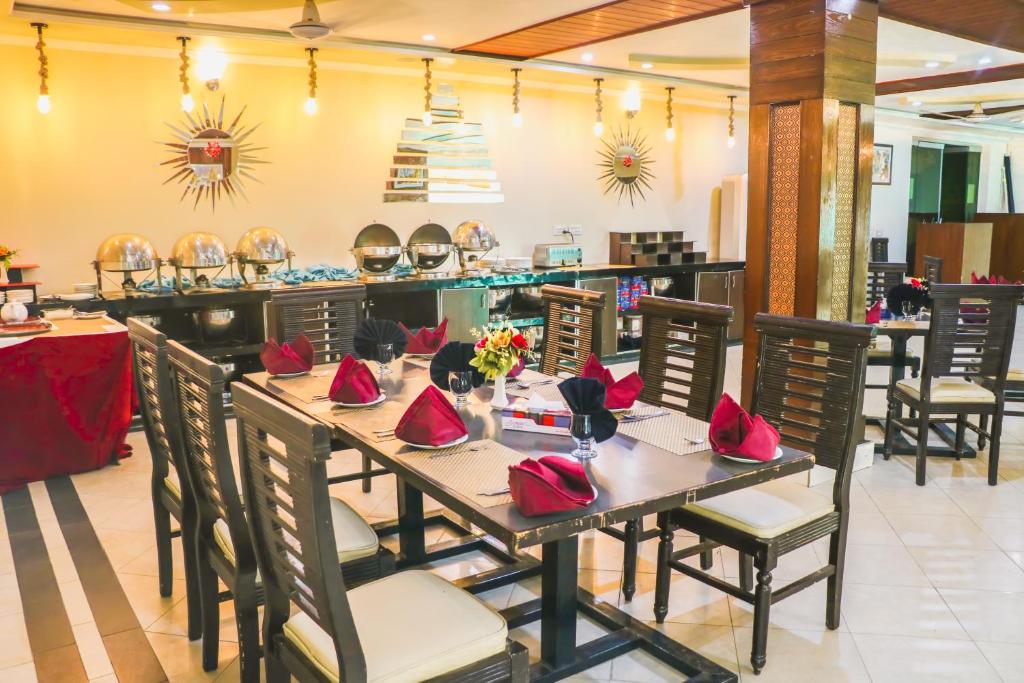 a dining room with a long table and chairs at Hotel Crown Inn Multan in Multan