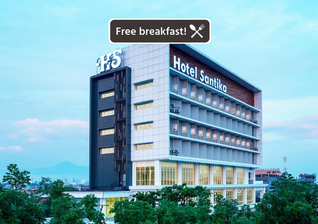 a building with a sign on top of it at Hotel Santika Pasir Koja Bandung in Bandung