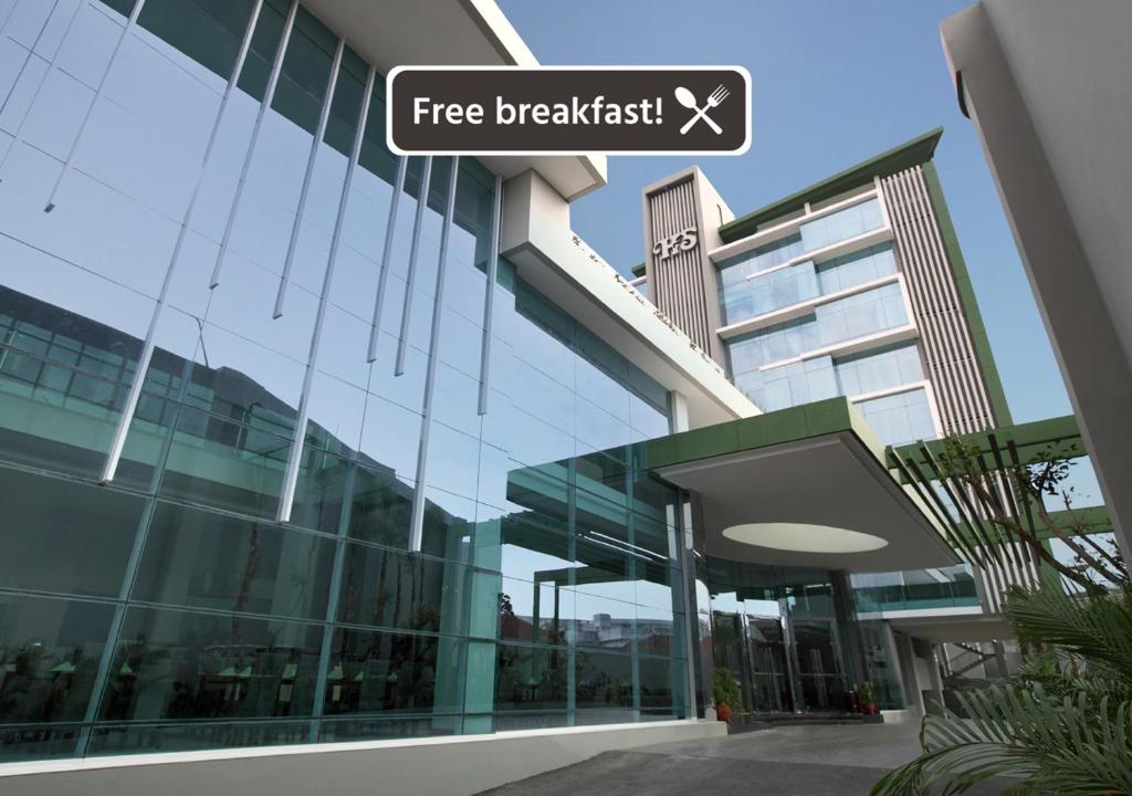 a building with a sign that reads free breakfast at Hotel Santika Tasikmalaya in Tasikmalaya