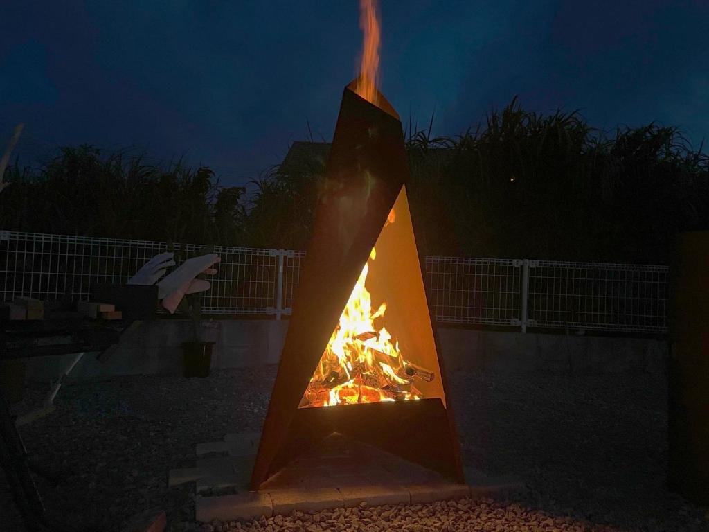 a fire pit in a yard at night at Hotel Yua - Vacation STAY 40741v in Nago