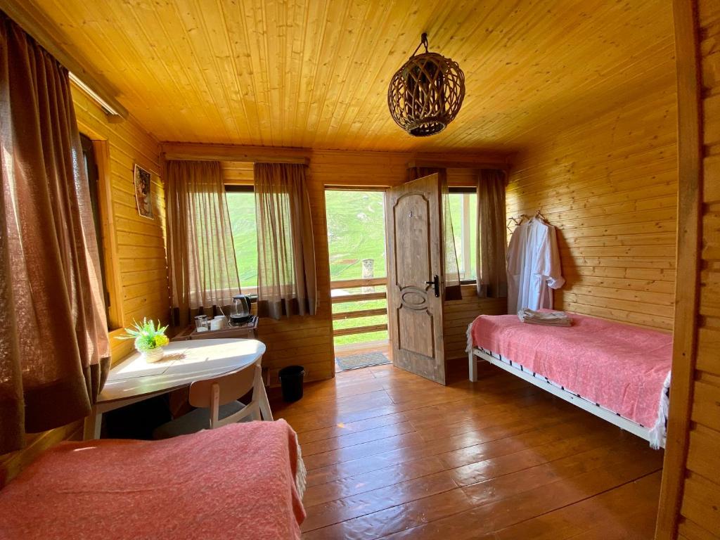 1 dormitorio con 1 cama y escritorio en una habitación en Ushguli Cabins, en Ushguli