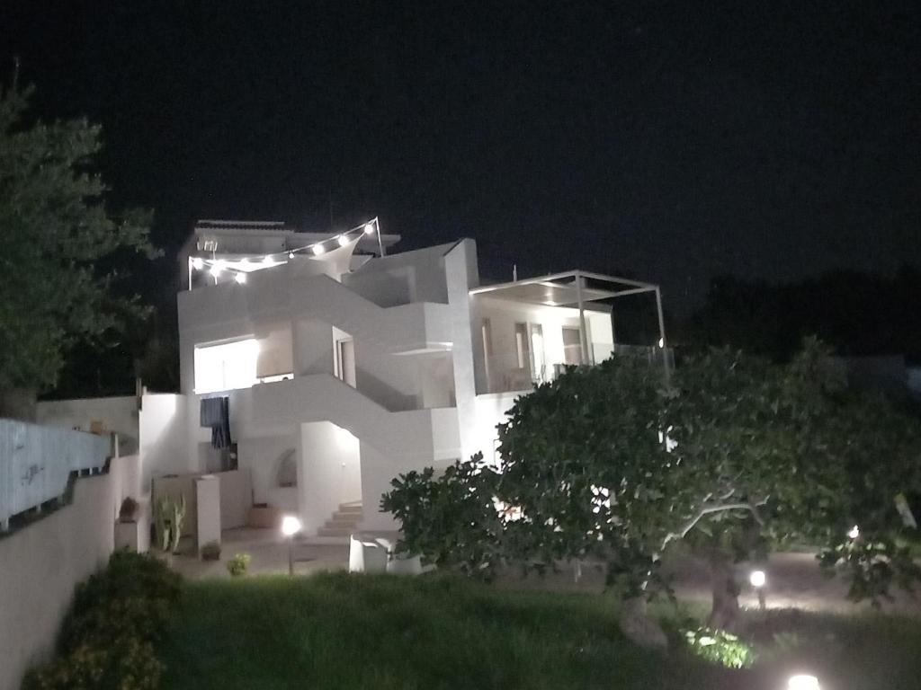 a white house at night with lights on it at la meridiana 2 in Santa Maria al Bagno