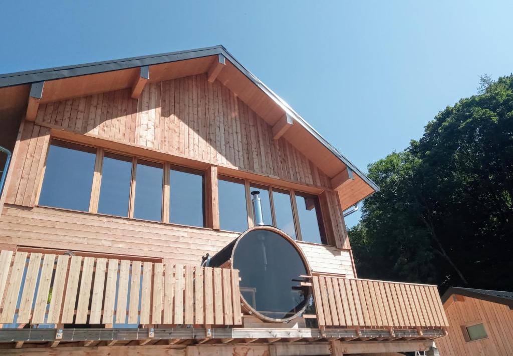 une maison avec une grande fenêtre à l'avant dans l'établissement Le Chalet Du Blanc Spa yoga, à Aillon-le-Jeune