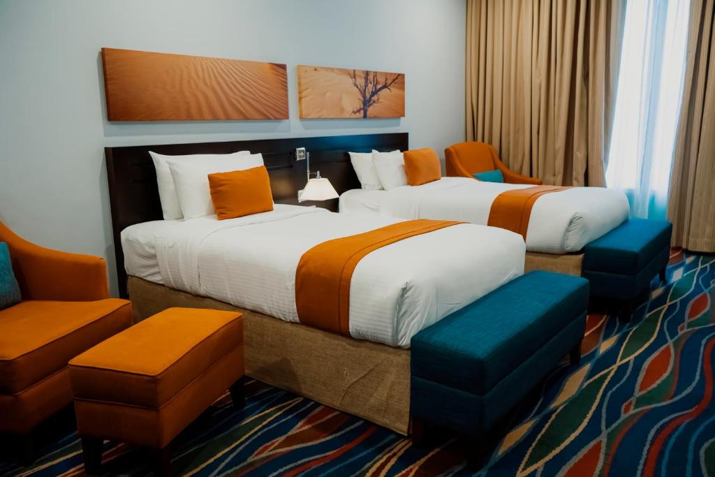 Postel nebo postele na pokoji v ubytování City Seasons Hotel & Suites Muscat
