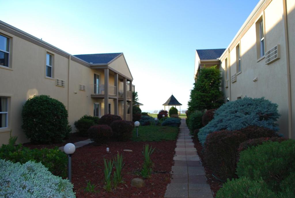 a walkway between two buildings in a yard at Clinton Inn & Suites in Port Clinton