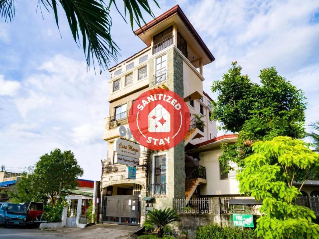 un edificio con una señal roja. en OYO 564 Casa Marga, en Cagayan de Oro