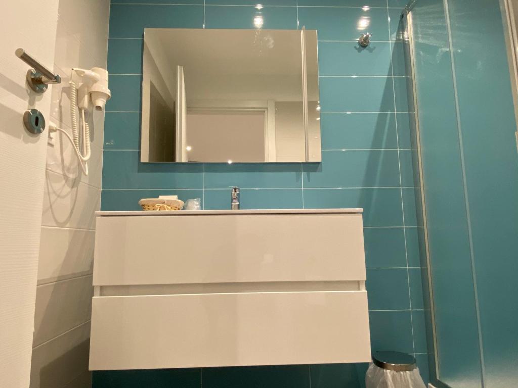 a bathroom with a sink and a mirror at Torre del mare Rooms in Bergeggi