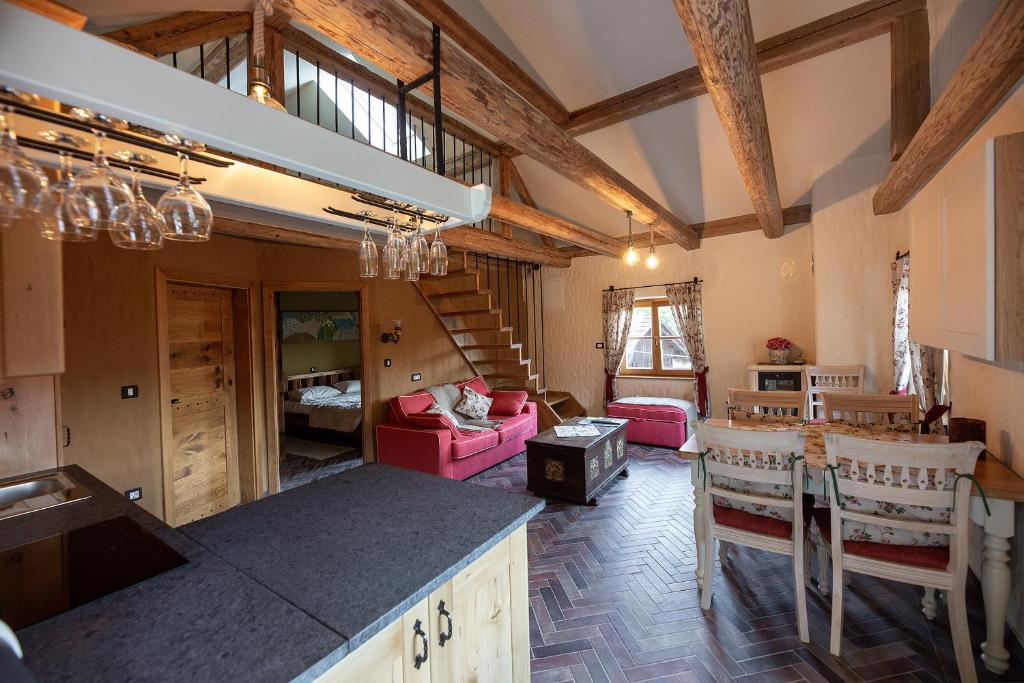 a kitchen and living room with a table and chairs at Rose garden in Ljubno