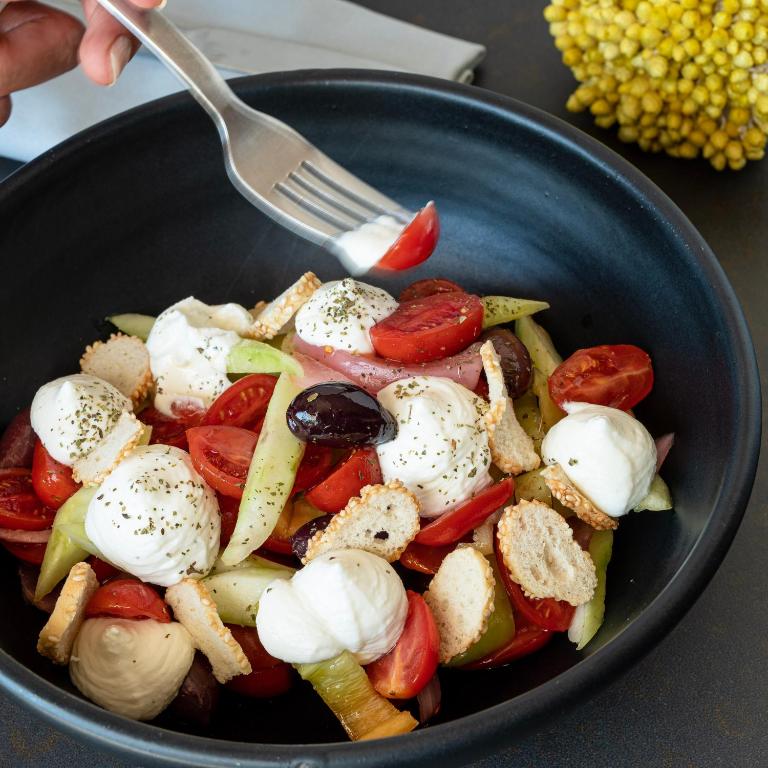 a bowl of vegetables with a fork in it at Somewhere Vouliagmeni in Athens