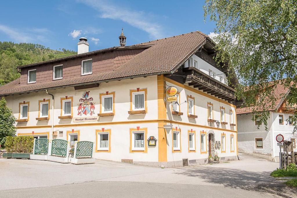 a large yellow building with a brown roof at Appartement Sophia in Sankt Martin