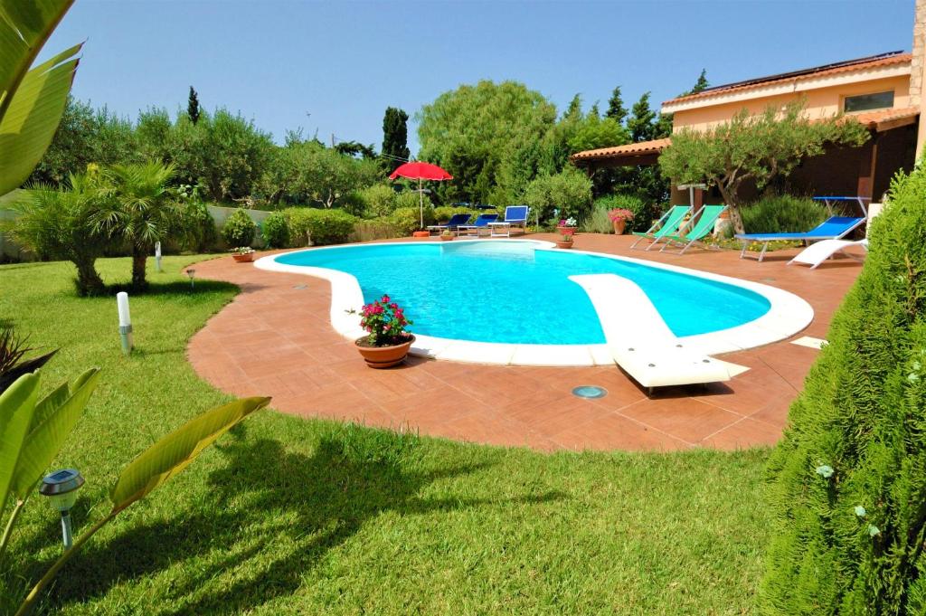 a swimming pool in a yard next to a house at Villa Sophia in Chiesa Nuova