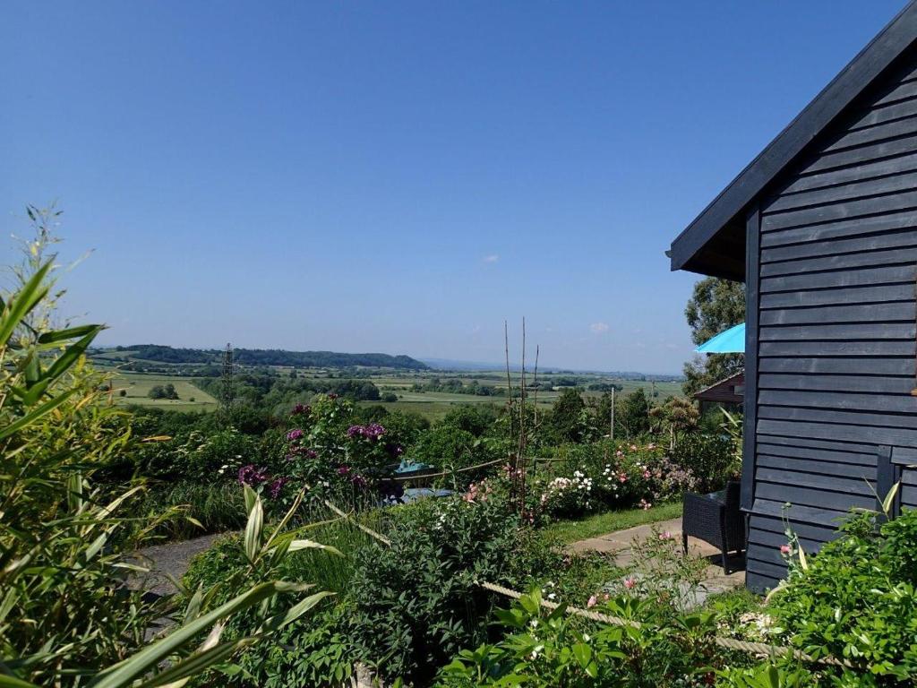 a house with a view of a garden with flowers at Rose Lodge in Aller