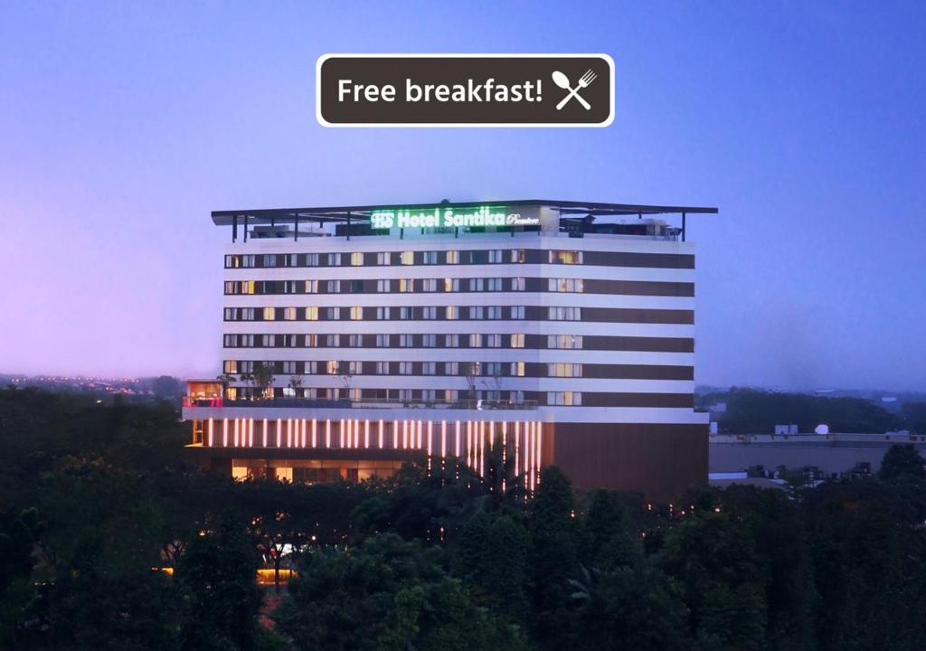 a building with a free breakfast sign on top of it at Santika Premiere Bintaro in Serpong
