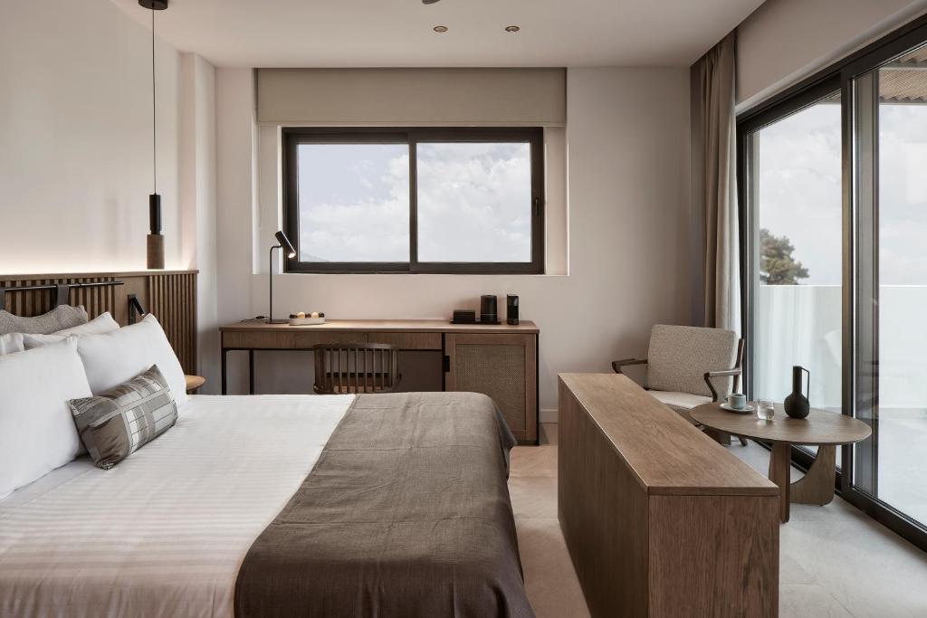 Postel nebo postele na pokoji v ubytování The Olivar Suites