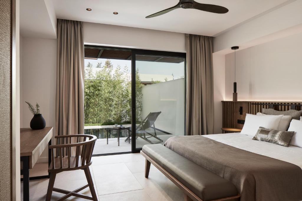 Postel nebo postele na pokoji v ubytování The Olivar Suites