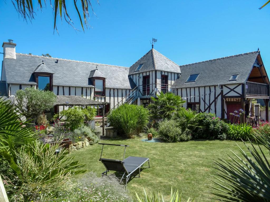an exterior view of a large house with a garden at Holiday Home Valhalla- chez Jules by Interhome in Planguenoual