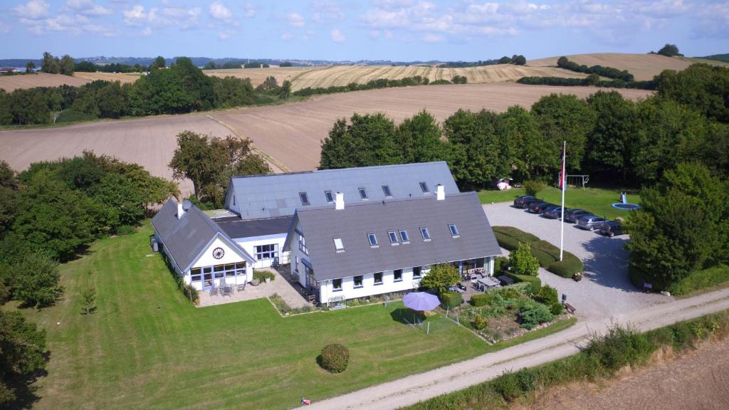 an aerial view of a large house on a field at Rolsø Retreat - the apartment in Knebel