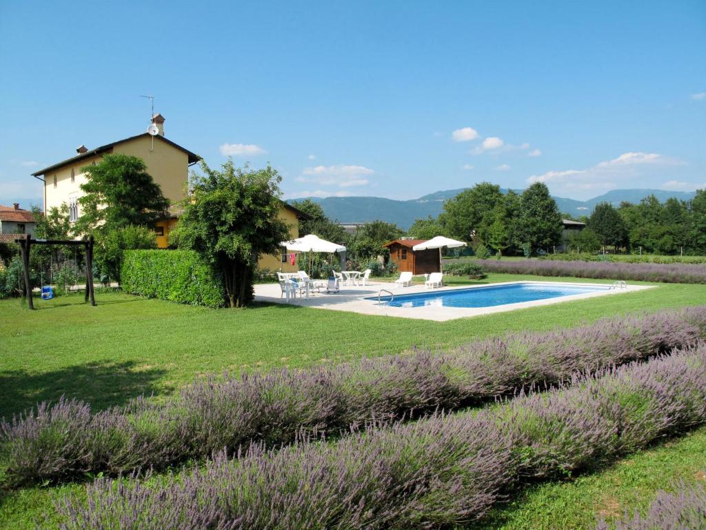 a garden with a swimming pool and a house at Holiday Home Domus Magna-4 by Interhome in Povoletto