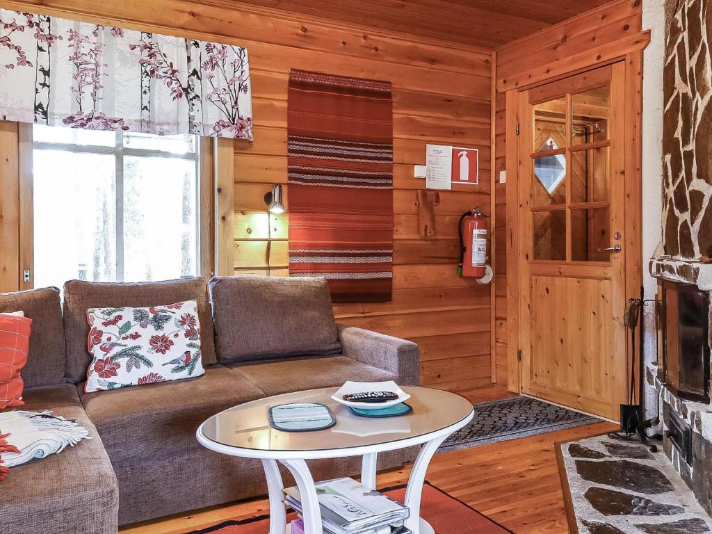 a living room with a couch and a table at Holiday Home Sallanrinne b by Interhome in Salla
