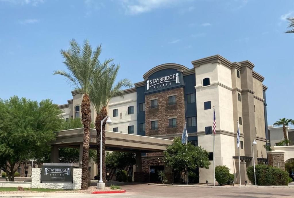 a hotel with a palm tree in front of a building at Staybridge Suites Phoenix Glendale Sports Dist, an IHG Hotel in Glendale