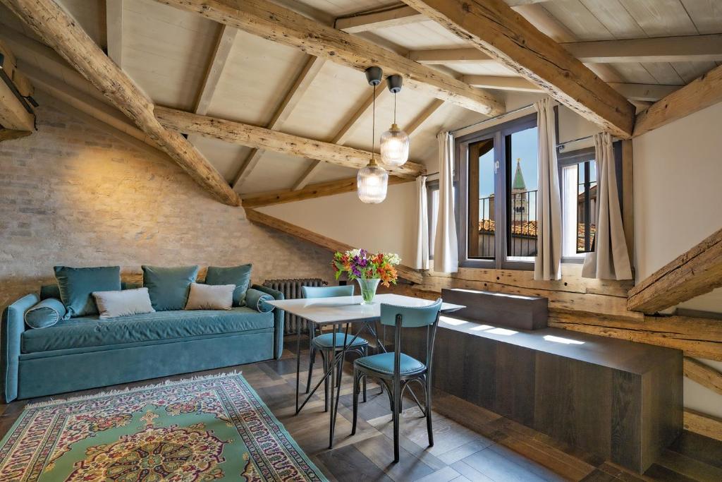 a living room with a couch and a table at Corte Rubbi 11 Secret Terrace Apartment in Venice