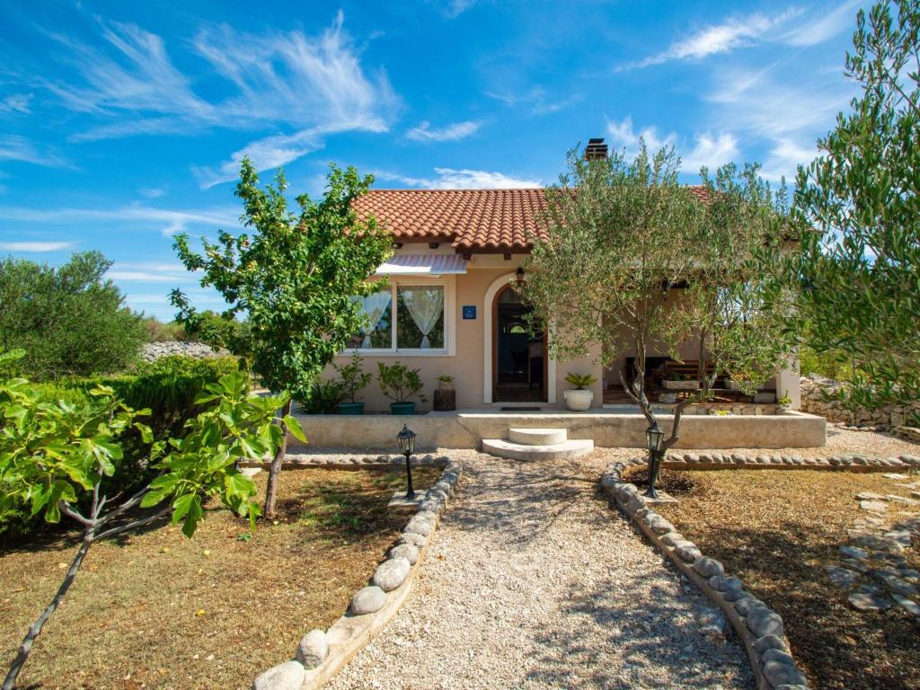 a house with a garden and trees in front of it at Holiday Home Ivana by Interhome in Srima