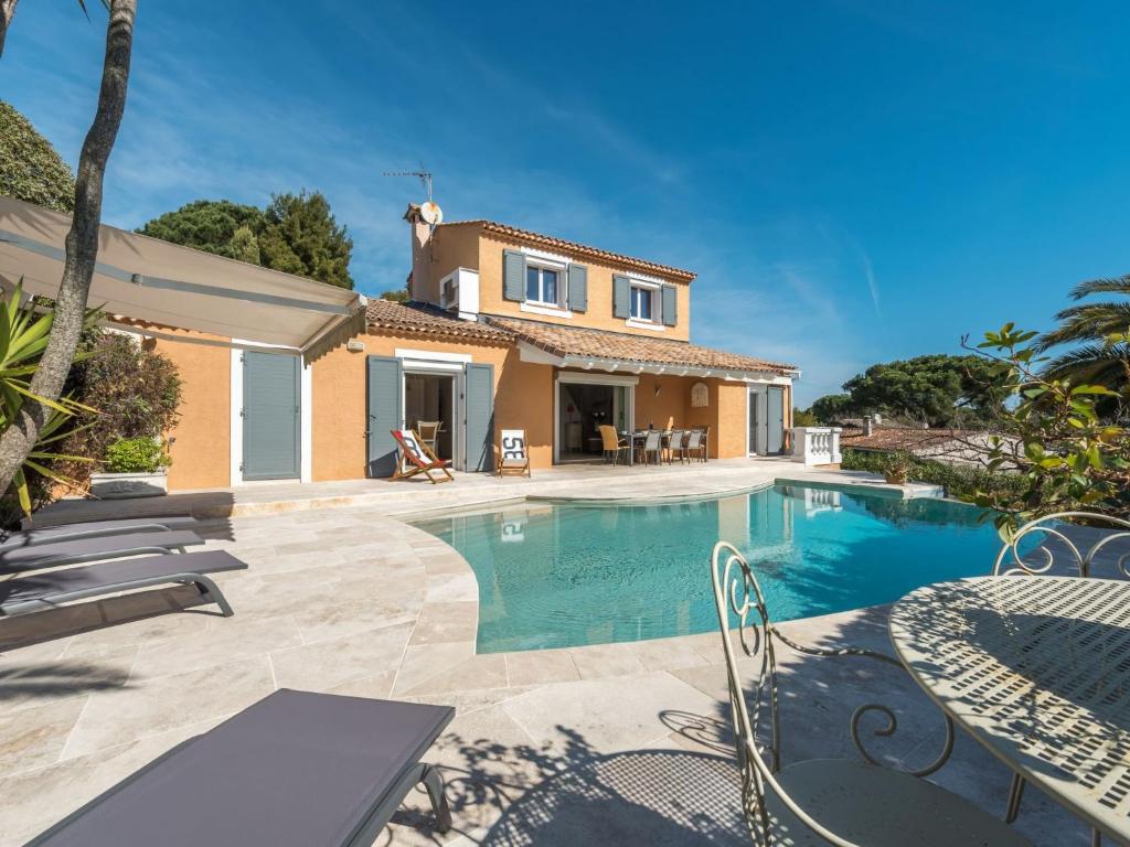 a villa with a swimming pool in front of a house at Villa Clos des collines by Interhome in Gassin