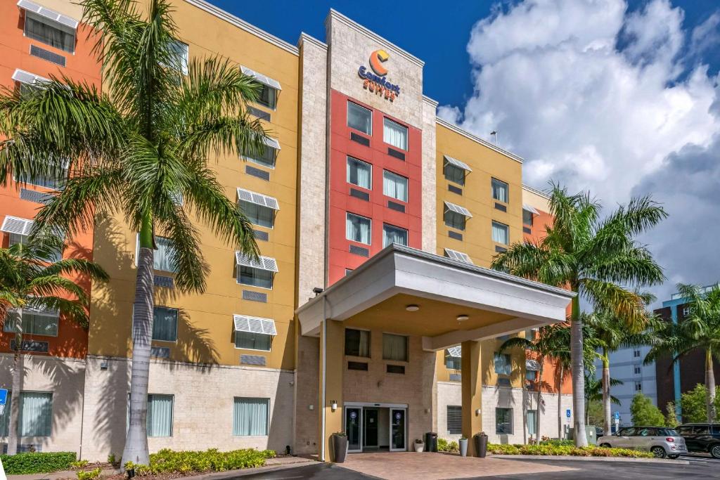 a large building with a large clock on the front of it at Comfort Suites Fort Lauderdale Airport South & Cruise Port in Dania Beach