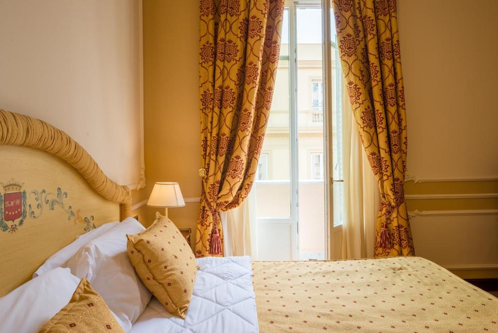 Postel nebo postele na pokoji v ubytování Grand Hotel Wagner