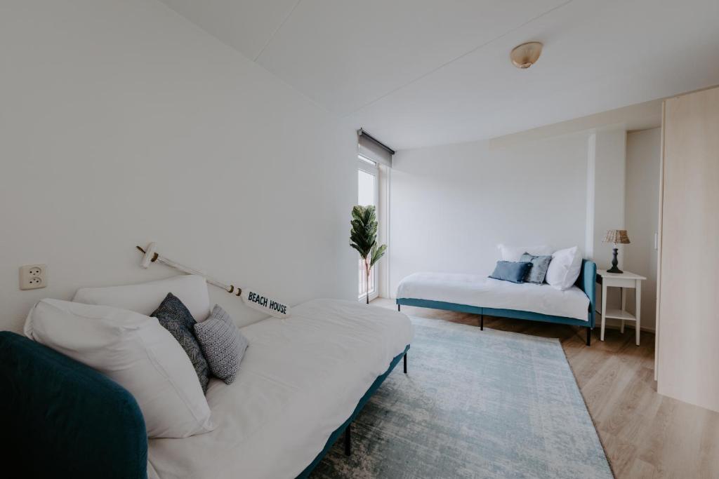 Voodi või voodid majutusasutuse Stijlvol appartement op strand Makkum toas