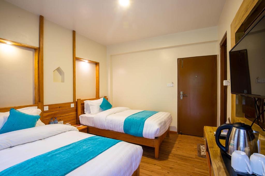 Postel nebo postele na pokoji v ubytování Hotel Himalayan Glacier