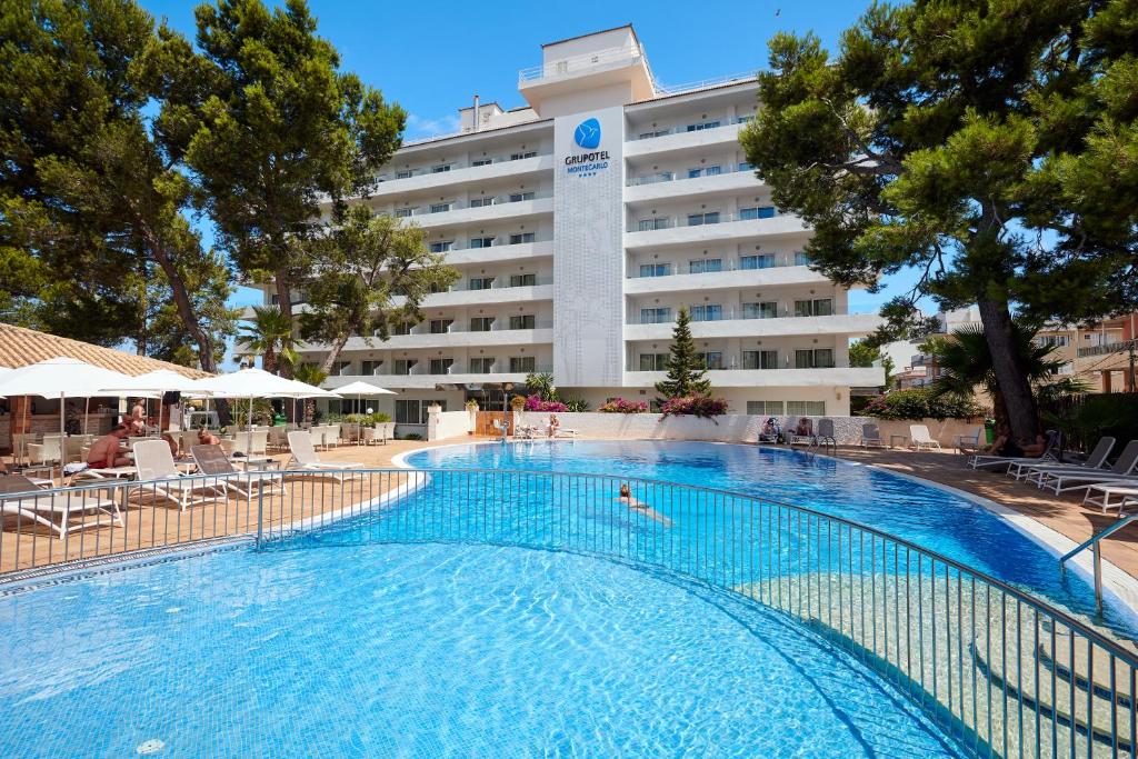 a large swimming pool in front of a hotel at Grupotel Montecarlo in Can Picafort