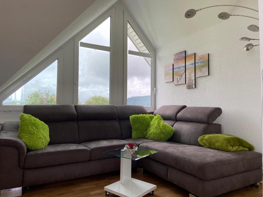 a living room with a couch and two windows at Sunshine in Messen