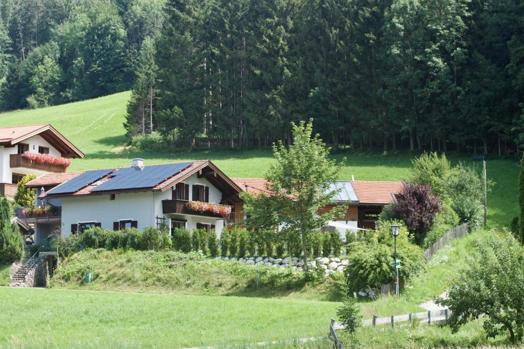 a house in the middle of a green field at Ferienwohnungen Mittermayer in Aschau im Chiemgau