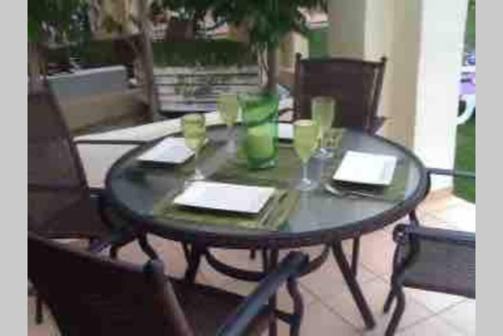 a table with two chairs and a table with drinks on it at Roda Golf & Beach Resort. Townhouse, Poolside in Murcia
