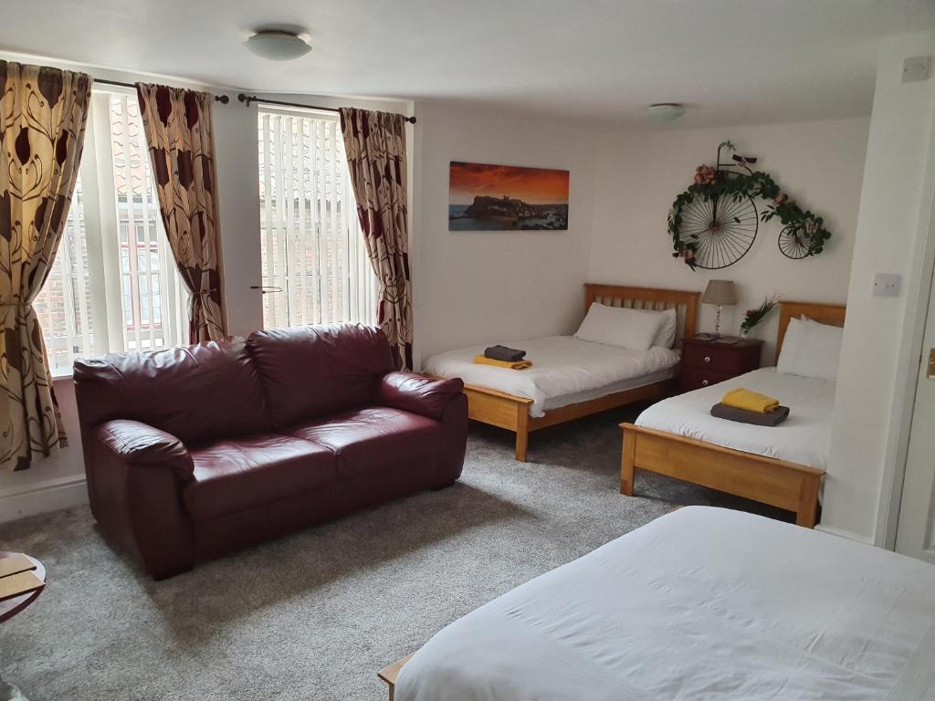 a living room with a couch and a bed at Chartwell Retreat in Whitby
