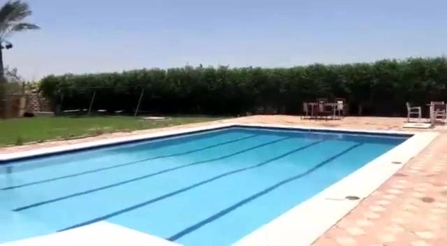 a large swimming pool with blue water at شاليه بالساحل الشمالى* in Kafret Eilet el Taflal