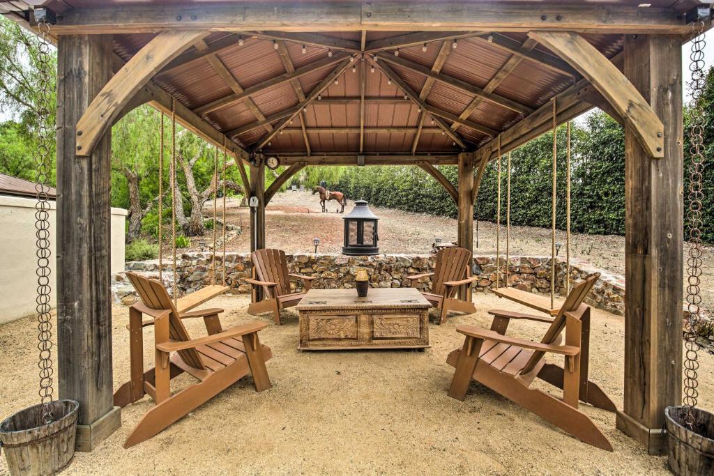 a wooden gazebo with chairs and a table at Rancho Santa Fe Casita - Gate Guarded Community! in Rancho Santa Fe