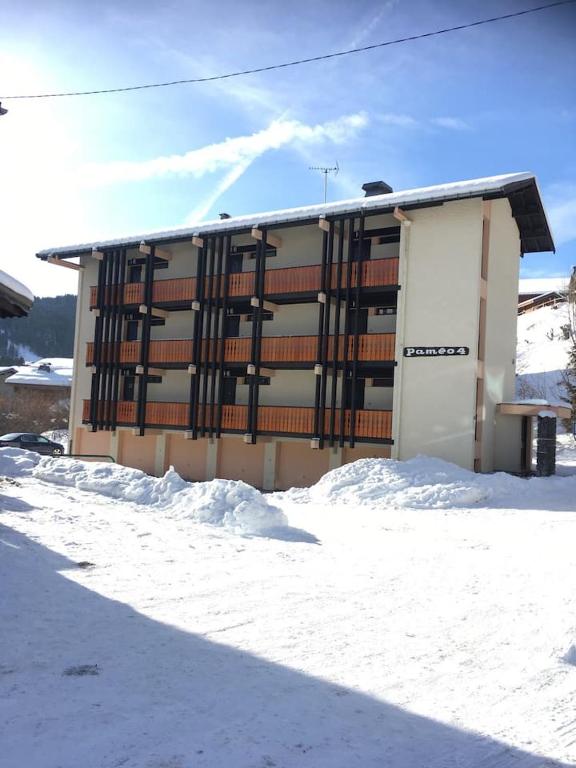 a building with a lot of snow in front of it at Les Gets apartment in Les Gets