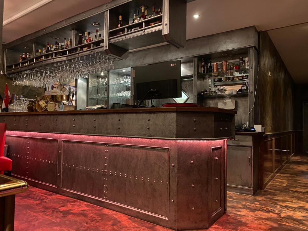 a bar in a restaurant with a red counter at Hotel Boxberg in Waldbröl