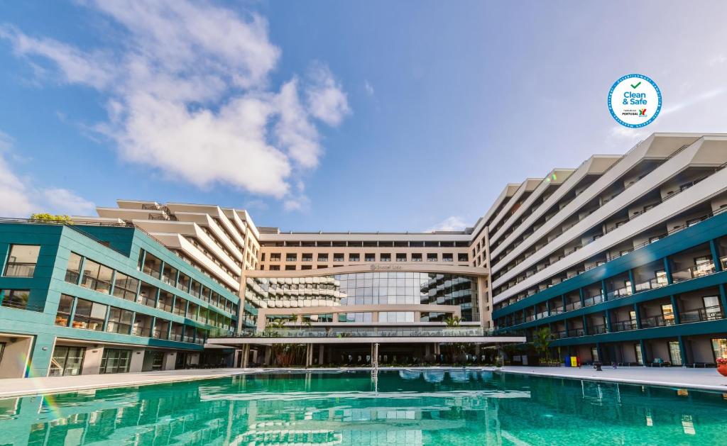 
a large swimming pool in a large building at Enotel Lido - All Inclusive in Funchal

