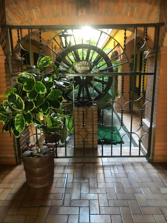 a wrought iron gate with a potted plant at Hotel Colonial Rivera in Iguala de la Independencia