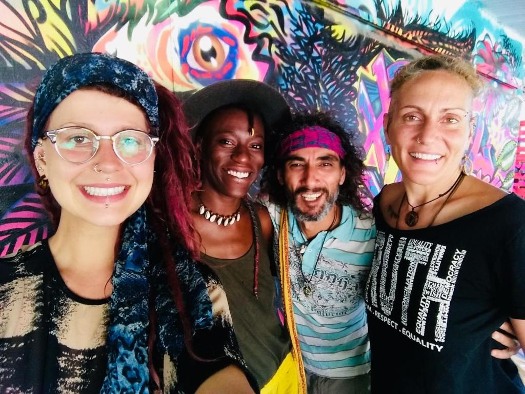 a group of people posing for a picture in front of a wall at Hostal La Casa de Juan in Valle de Anton