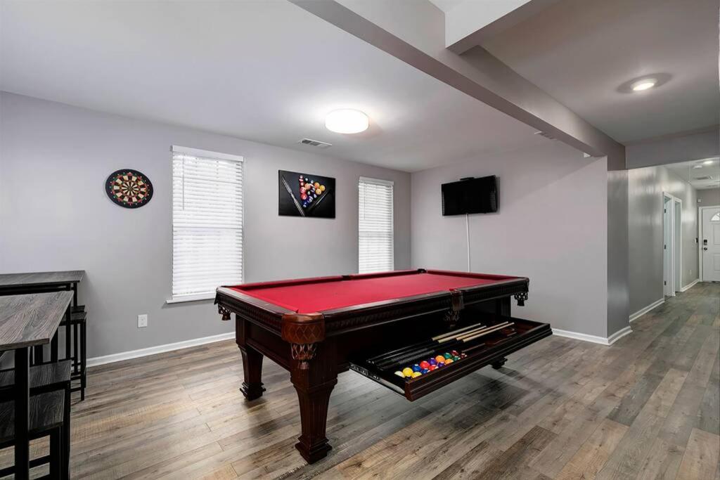 a living room with a pool table in a room at Relaxing Luxury Near Airport & Downtown Atlanta in Atlanta